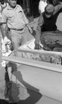 African American man selecting fish from cooler