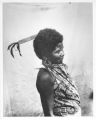 Negrito woman showing wedding comb, also a little flower in her ear to ward off headache