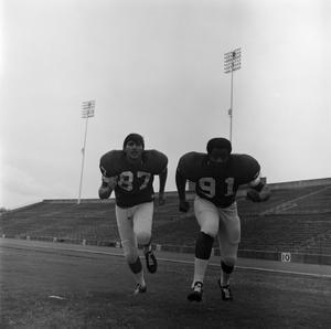 Two football players running, 11