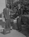 Mr. Ware of the Coca-Cola Bottling Company in Montgomery, Alabama, presenting a case of drinks to the dean of men at the junior college department of the Alabama State College for Negroes.