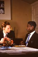 White minister and African American man at dinner