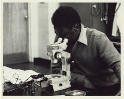 African American engineering student at microscope; Stuart Abbey