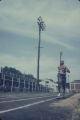 Runner on the track during the annual high school track meet of the Alabama Interscholastic Athletic Association, probably held in Montgomery.