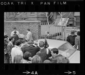 Press waiting for Boston University President Dr. Arland Christ-Janer as he exits gates