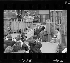 Press waiting for Boston University President Dr. Arland Christ-Janer as he exits gates