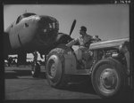 Production. B-25 "Billy Mitchell" bombers. A Negro employee at the flight ramp of North American's Inglewood, California, plant, tows a B-25 bomber into place. In addition to the battle-tested B-25 "Billy Mitchell" bomber, used in General Doolittle's raid on Tokyo, this plant produces the P-51 "Mustang" fighter plane which was first brought into prominence by the British raid on Dieppe