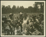 Two white and four African-American men in fields of tobacco