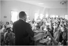 Martin Luther King, Jr., speaking to an audience in a church building, probably First Baptist Church in Eutaw, Alabama.