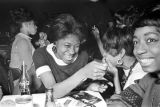 Barbara Howard Flowers with her sister, Princilla Howard, and another women, seated at a table at the Laicos Club in Montgomery, Alabama.