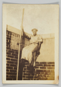 Photographic print of a woman on a brick wall