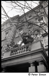 Umoja (Black student union) activists hoisting a television to occupiers of the administration building, Boston University