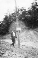 Unidentified man leaning on a post at Nathans Gap