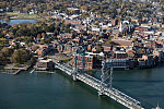 An October 2017 aerial view of the historic seaport of Portsmouth, New Hampshire, the largest city along the shortest coastline (18 miles) of any U.S. state. Portsmouth connects via the Memorial lift bridge (foreground) to Badger's Island, which is in Maine waters; that island, in turn connects to Kittery, the southernmost point of mainland Maine