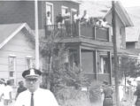 Citizens survey scene from second story porch after riot, Rochester, NY, 1964