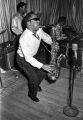 Bobby Moore playing the saxophone on stage at the Laicos Club in Montgomery, Alabama, during a performance by his group, Bobby Moore and the Rhythm Aces.