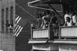 Onlookers watching Martin Luther King, Jr.'s funeral procession from a balcony.