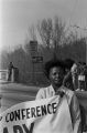 Woman holding the corner of an SCLC banner during the 20th anniversary reenactment of the Selma to Montgomery March in Selma, Alabama.