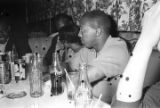 Robert Flowers and others, seated at a table at a club, probably in Montgomery, Alabama.