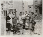 Group posing at street kitchen. Unidentified location