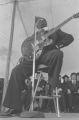 B. B. King: New Haven, Conn. Yale University Graduation. B. B. King at podium, performing at graduation ceremony (BKP 26-77-5/15)