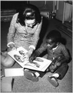 Alpha Lambda Delta member reading with boy