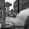 Firemen spraying civil rights demonstrators with a hose during the Children's Crusade in downtown Birmingham, Alabama.