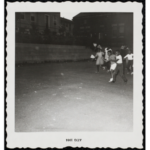 Contestants and their brothers running a three-legged race during a Boys' Club Little Sister Contest