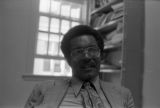 John Blassingame: New York. John Blassingame seated in office, Fredrick Douglas portrait on the wall (BLJP 1-79 #101)