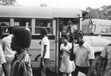 Students getting off Wilcox County school buses at the high school in Pine Hill, Alabama.