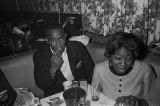 Barbara Howard Flowers and another man seated at a table at a club, probably in Montgomery, Alabama.