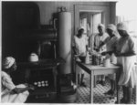 [5 African American girls baking in kitchen]