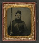 [Unidentified soldier in Union uniform with musket, revolver, and bayonet with scabbard]