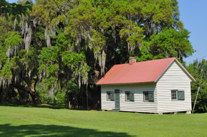 [South Mulberry Plantation]: an old slave cabin has been converted into an art studio.