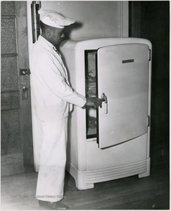 Storer College Student in Cooking Class Looking in a Refrigerator, Harpers Ferry, W. Va.