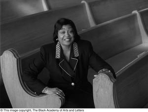 Dorothy N. Cole Davis seated among the pews of a church #3