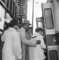 Fred Shuttlesworth and other African Americans waiting to board a bus during an integration attempt in Birmingham, Alabama.