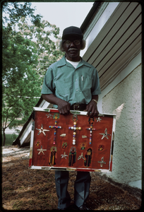 Outsider art: Theodore Hill. Theodore Hill with one of his visual art pieces