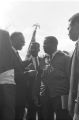 Fred Shuttlesworth, Ralph Abernathy and others talking in the street at Martin Luther King, Jr.'s funeral.