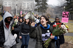 Justice for Jason rally at UMass Amherst: UMass student Talleen Navarian shouts chants into a bullhorn as she an other students and staff rally through campus in support of Jason Vassell