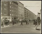 [African American men walking across downtown street]