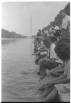 [Demonstrators sit, with their feet in the Reflecting Pool, during the March on Washington, 1963]