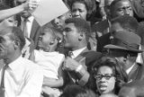 Muhammad Ali with a little girl, sitting in the bleachers during homecoming activities for Alabama State College on Thanksgiving Day in Montgomery, Alabama.