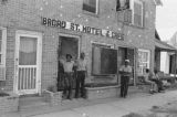 James "Son" Thomas and Joe Cooper in Leland, Mississippi. Bar, shoeshine parlor, promotional posters. (JTP 5-76-3)