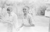 Amy Peppler and Julia Hendricks carrying eggs gathered from a hen house at the Hendricks home in the Madison Park community in Montgomery, Alabama.