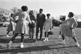 Muhammad Ali on the football field with the mascot and cheerleaders from Tuskegee Institute during homecoming activities for Alabama State College on Thanksgiving Day in Montgomery, Alabama.