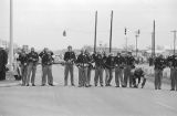 Alabama state troopers in gas masks and riot gear, waiting for civil rights marchers on the south side of the Edmund Pettus Bridge in Selma, Alabama, on Bloody Sunday.