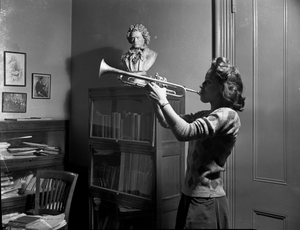 Woman playing trumpet : black-and-white photonegative