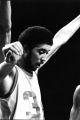 Bo Ellis raises his arms during a basketball game, 1975