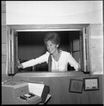 Woman posing in an office window, Los Angeles, 1971