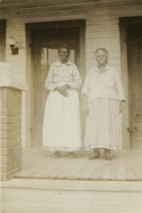 Two Gullah women in front of a house